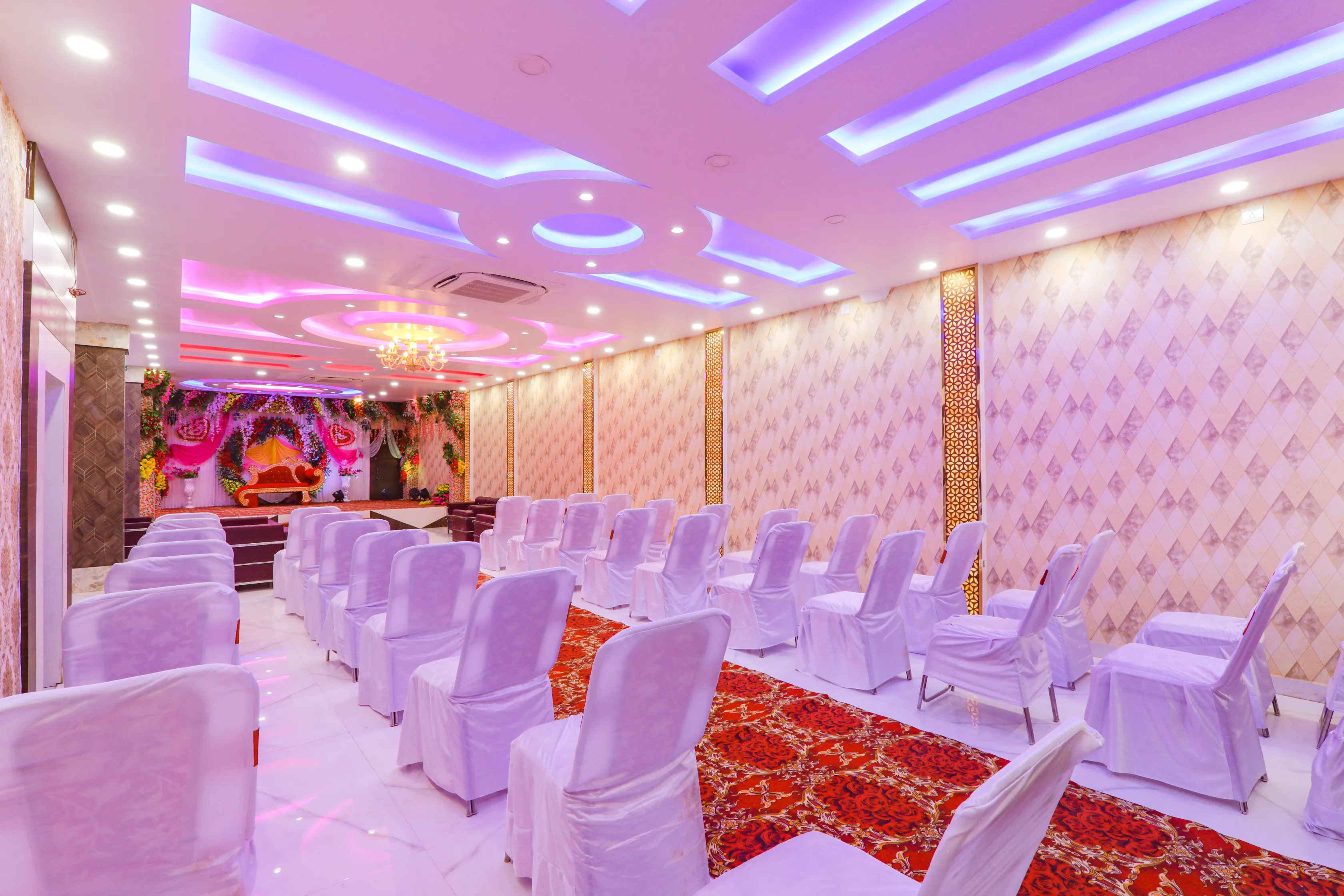 Marriage hall seating with floral wedding mandap stage in Madhubani